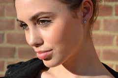 Model with three quarter round brilliant cut diamond studs